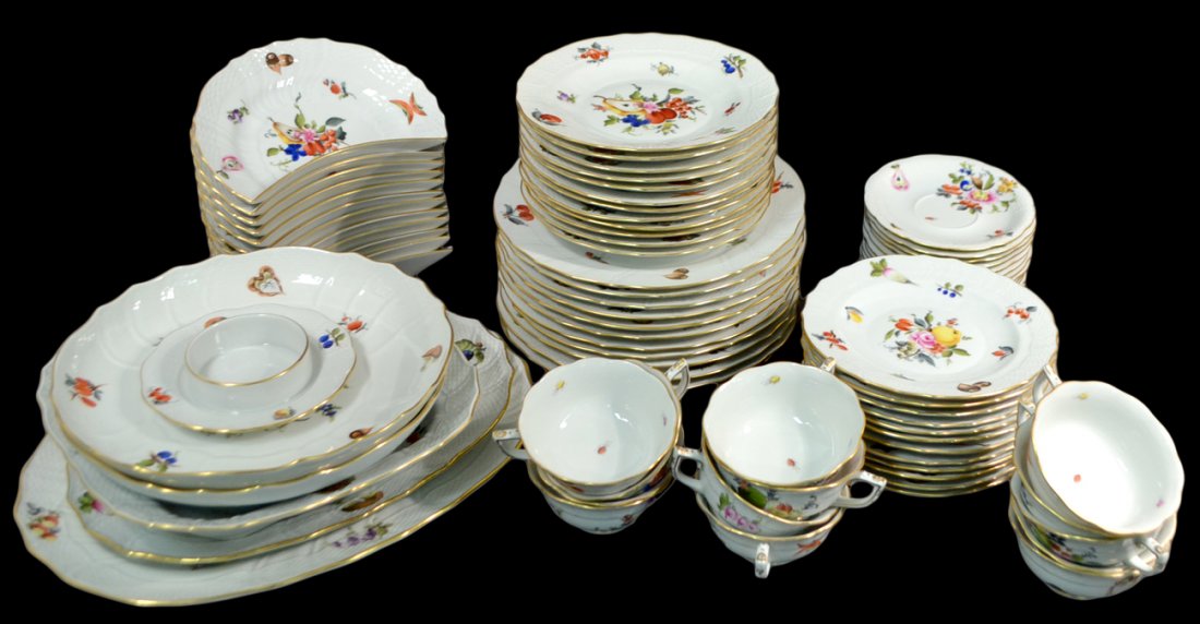 80 Piece Herend Porcelain Dinner Service: Comprises 12 dinner plates, 12 luncheon plates, 12 cresent plates, 12 bread and butter plates, 13 cups, 13 saucers, and 6 serving pieces. Floral, fruit and insect decoration. Good condition.