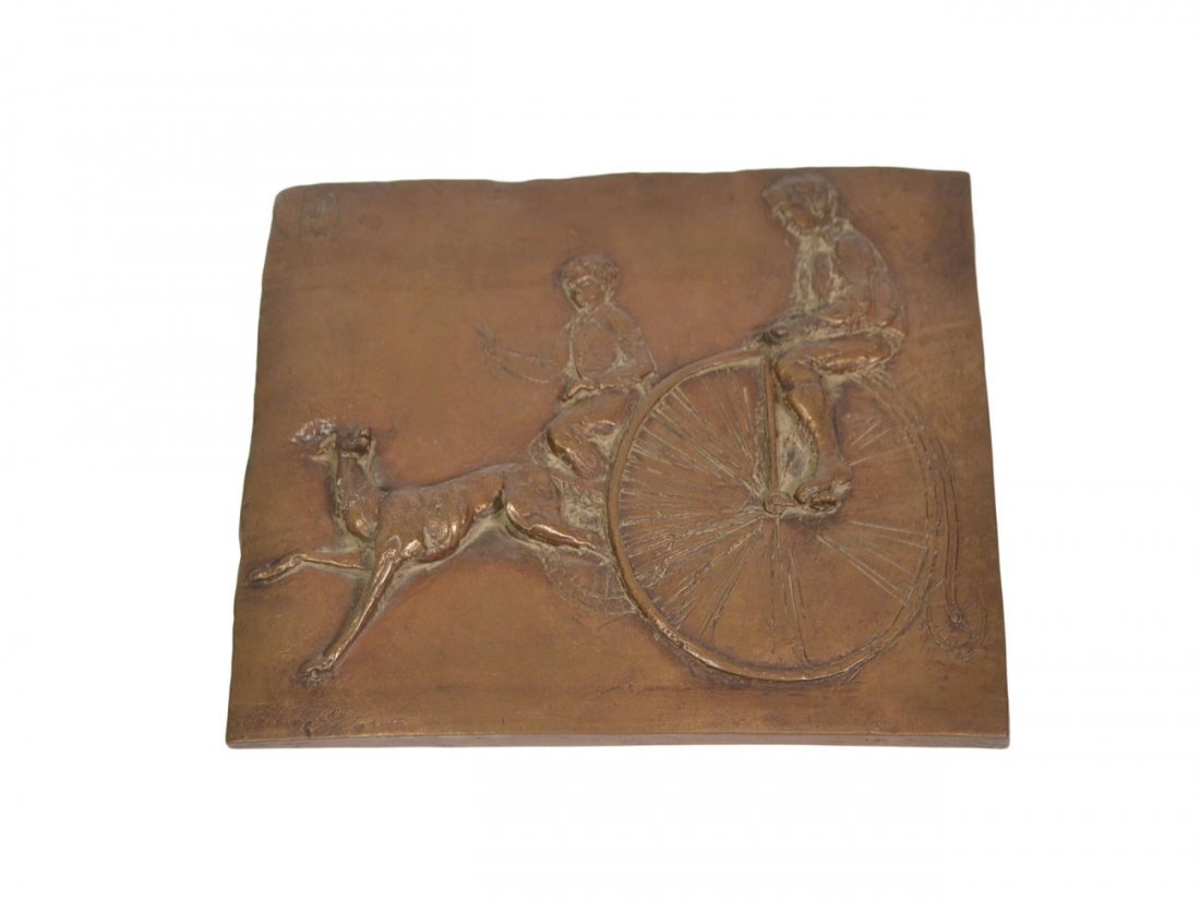 Bronze Plaque: Bronze relief plaque of boys riding penny farthing bicycles with a dog running in front of them. Signed "dP" on the upper left corner and also an initial of "Sc" on the bottom right edge. [9 1/4" W x