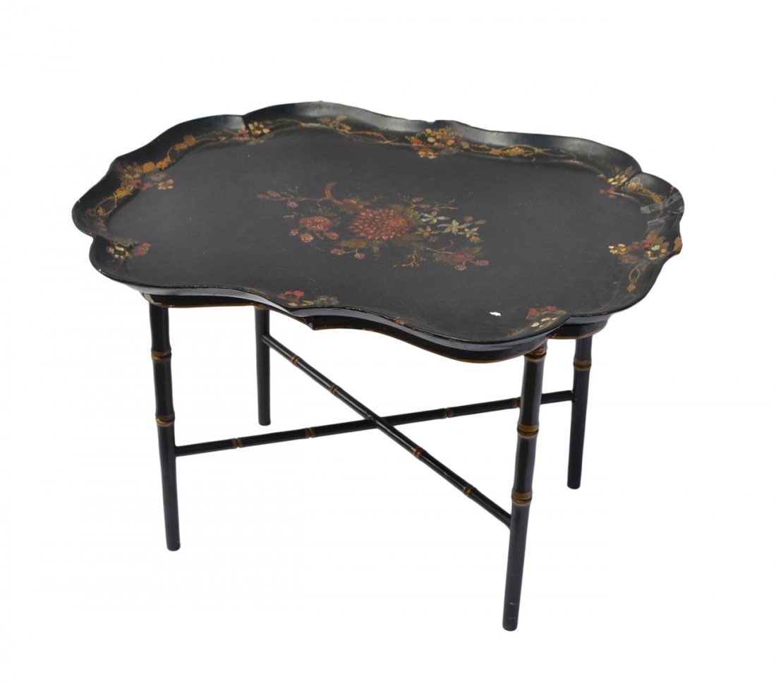 Antique Papier Mache Tray on Stand: Scalloped and raised edge tray with floral decor on a vintage black and gold patterned faux bamboo stand. [30 1/2" W x 22 3/4" D x 21" H]. Chips with losses and wear.