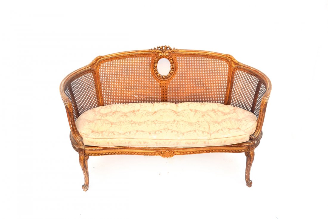 Louis XVI-Style Settee: French gilt wood Louis XVI-style settee with tufted cushion, caned back and arms. [57 1/2" W x 24" D x 35 1/2" H]. Loss to paint. Caning damaged, otherwise structurally good condition.