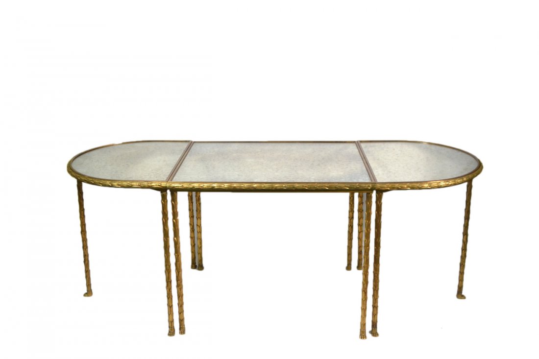 Bagues Bronze Tri-Part Coffee Table: Comprises a central rectangular section flanked on either side by D-form table, all with mirrored tops. The frame cast in palm stalk form, and with paw feet. [44 1/2" W x 16 1/4" D x 17" H]. Frame bea