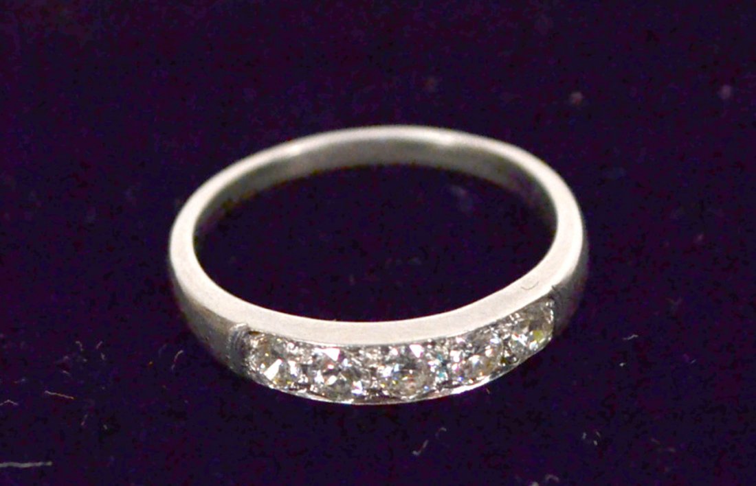 Platinum and Diamond Wedding Band: Platinum band mounted with 5 round-cut diamonds. Good condition.