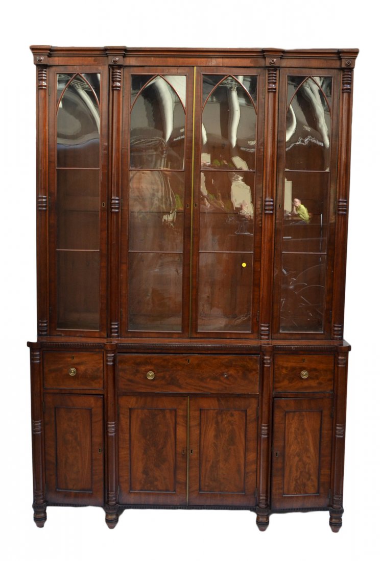 Antique Georgian Secretary Breakfront: Mahogany secretary with drop-front center compartment bearing retractable writing surface, flanked by two drawers above four doors. Features bookcase above with four antique glazed doors. Bearing poin