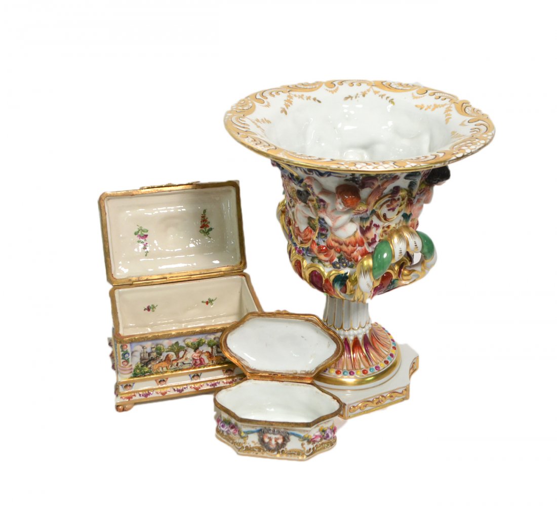 Three Piece Capodimonte Porcelain: Three pieces of Capodimonte porcelain comprising of one small hinged box, one medium hinged box, and one large vase. Each marked on the bottom. [Vase: 8 3/4" W x 10 1/4" H]. Good condition.