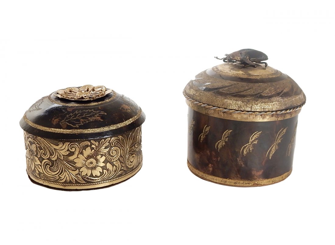 Two Bronze Cylindrical Boxes: Comprises: 1). Box with patinated and chased decoration, mounted with a metal beetle form handle. [4 5/8" H, in good condition, bearing a fabric lined interior. 2). Circular box with a variety of flor