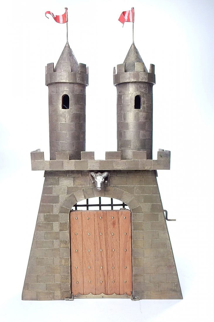 Bronze Castle Gate: Chased bronze architectural model of a castle, with operational gate. The wood fall front gate is mounted with a small figure of a jester in the act of inscribing "La Belle Dame hath me, the Castle's