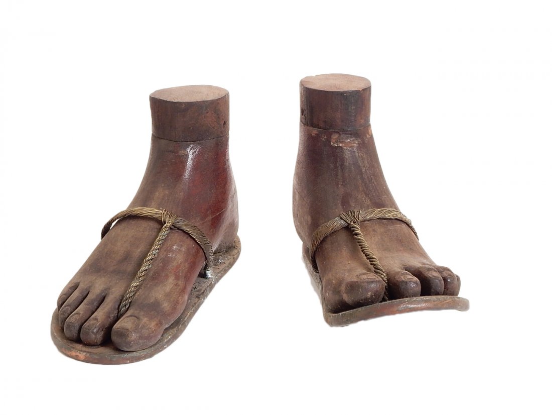 Pair of Carved 19th Century Feet: Appropriated 19th century mahogany carved Santos feet with hand made welded copper sandals and brass braided straps. [8 1/2" x 5"]. In good condition.
