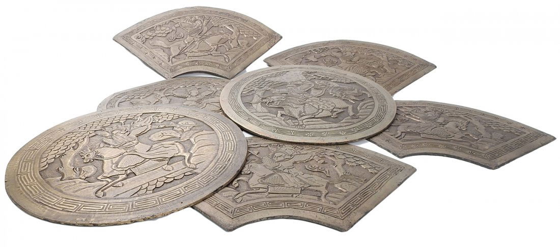 Chinese Bronze Plaque: Seven bronze/brass circular plaques with warriors riding horses and foo lions. [10" D]. In good condition.