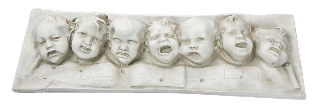Plaster Cast of "Children Singing": Plaster cast featuring 7 children singing above a scroll of music. [8 3/4" W x 3 1/2" x 27" L] In good condition
