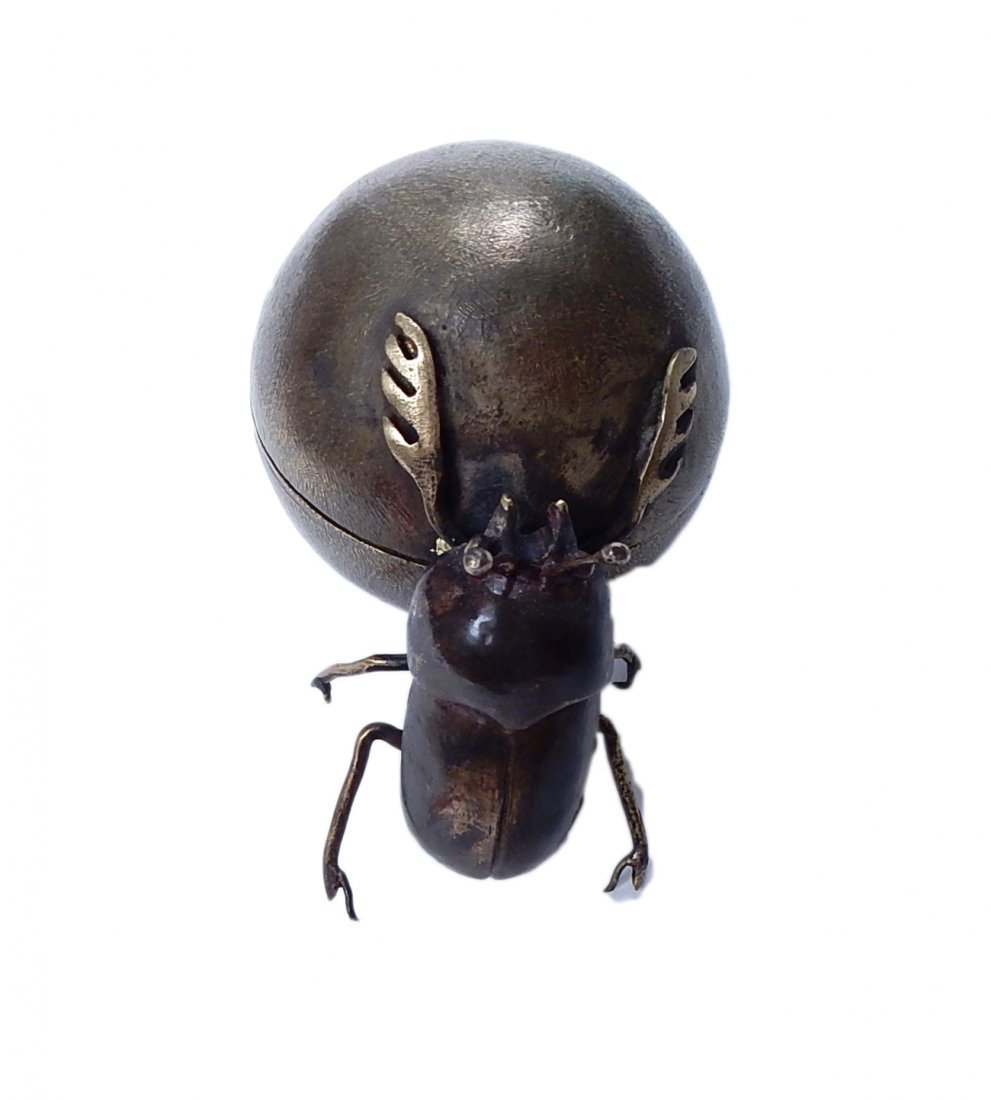 Beetle Box: Patinated spherical box mounted with climbing beetle with the interior bearing the figure of a newly hatched larvae. [3" W x 1 3/4" D x 2" H].