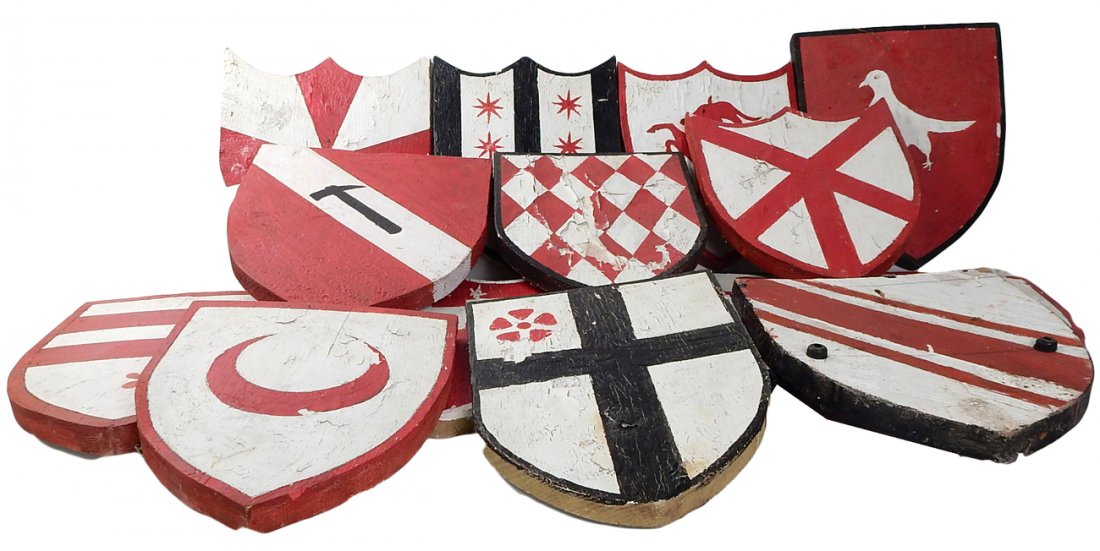 14 Painted Wood Shields: 14 wood shields painted with various coats of arms in black, red, and white. [Approximate size: 10" x 12 1/2"]. Paint flaking, sold "as is".