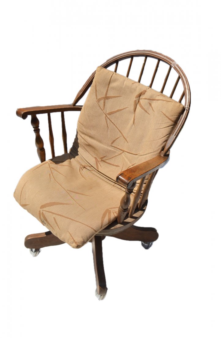 Windsor Style Chair: Windsor style maple swivel arm chair with spinder curved back. Sits upon a four legged base on casters. [25 1/2" x 17" D x 38" H] Condition: splits in wood