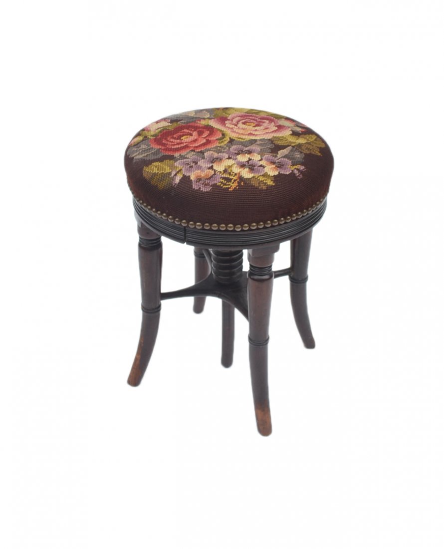 Victorian-Style Piano Stool: Mahogany Victorian-style piano stool with floral needlepoint ornamentation on seat. [13 1/2 Dia. x 18" H]. Wear to bottom legs.