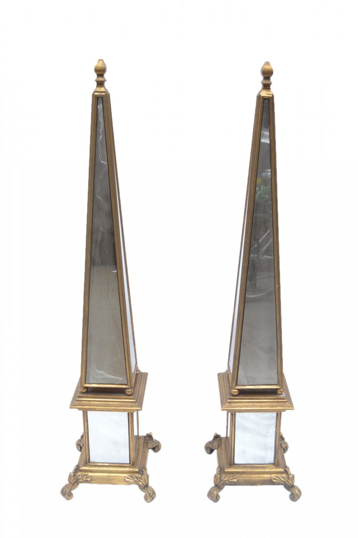 Pair of Mirrored Obelisks: Pair of wood and mirrored obelisks. One obelisk with "as is" panels (imperfections in glass). [Base: 12 1/2" x 12 1/2", x 57 1/2" H].