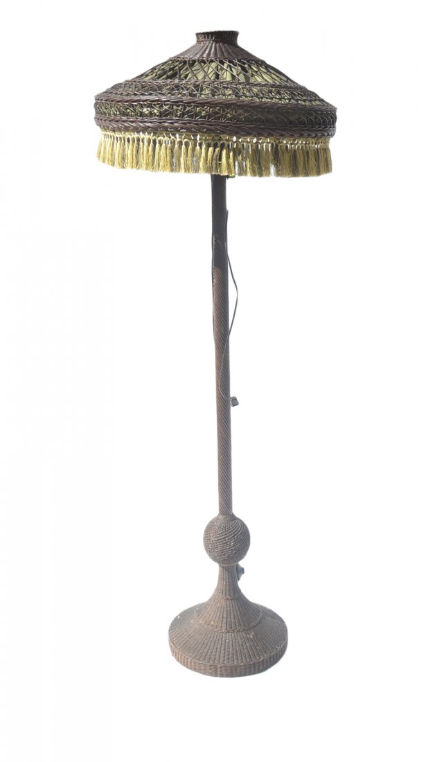 Large Metal/Rattan Floor Lamp: Large metal and rattan floor lamp with rattan and fringe lamp shade. [Approx: 73" H (including shade)]. Wiring not tested, otherwise in good condition.