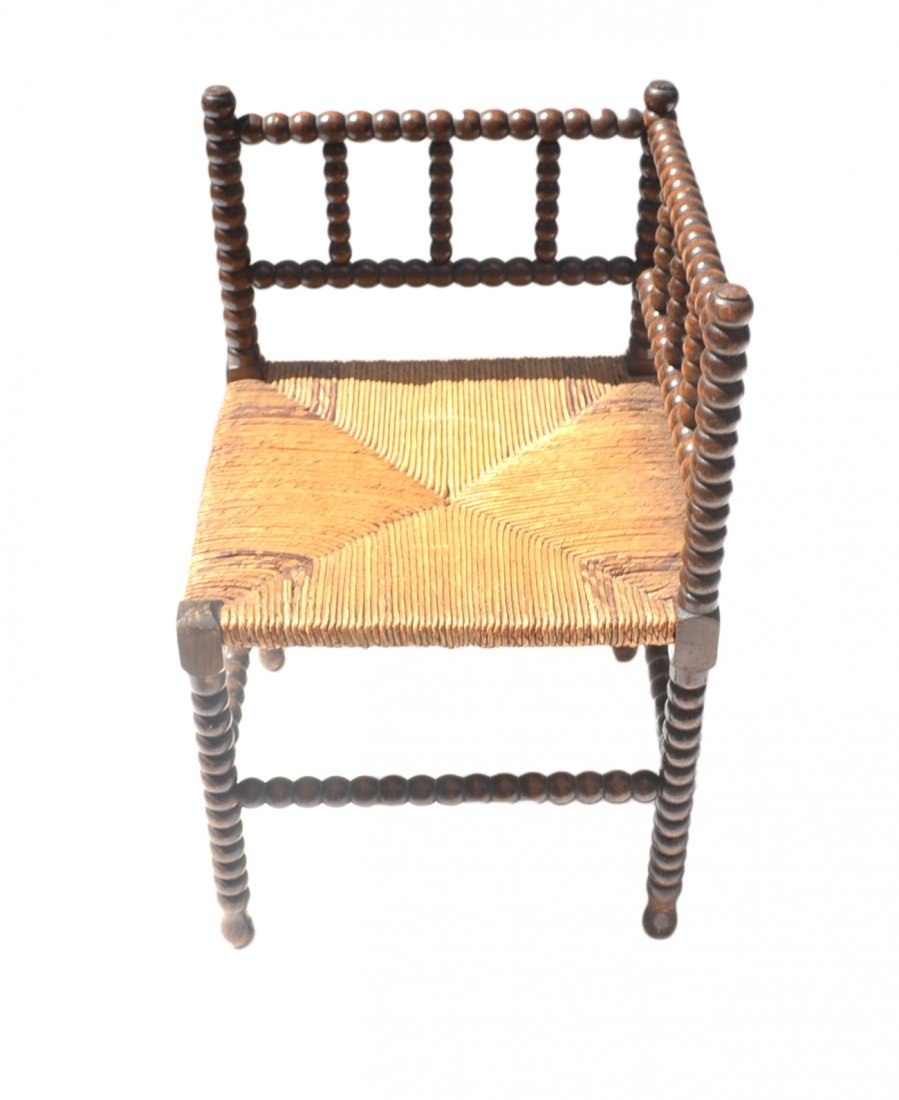 Small Rattan Corner Chair: Small corner chair with spindle arms and legs with rattan seat. [Approx: 16" x 16" x 24" H; To Seat: 14 1/2"].