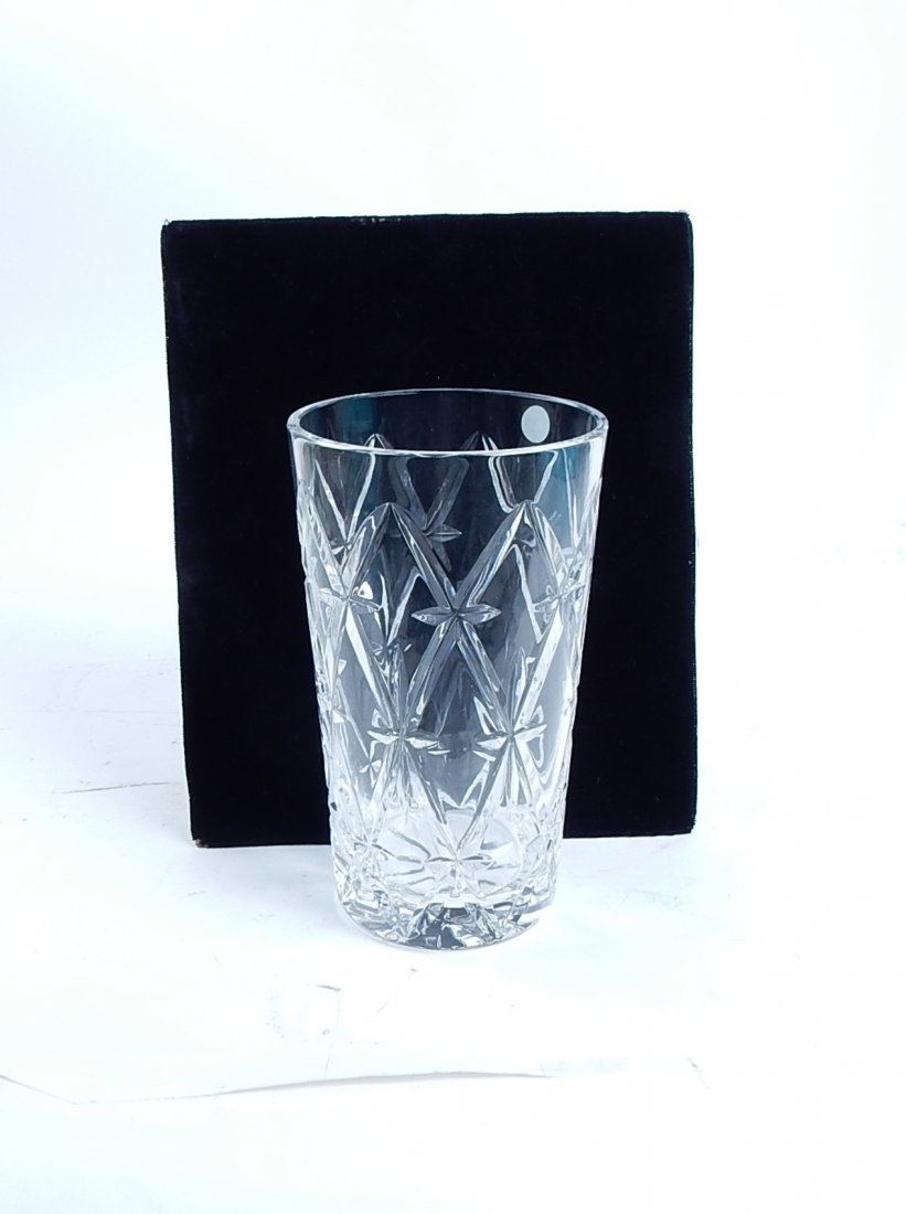 Irish Crystal Tiffany Vase: Irish cut crystal vase made by Tiffany & Co. Sticker affixed in vase states "Made in Ireland" and "Tiffany & Co". Comes in original Tiffany box. [6 7/8" H x 4" Dia]. Very good condition, like new.