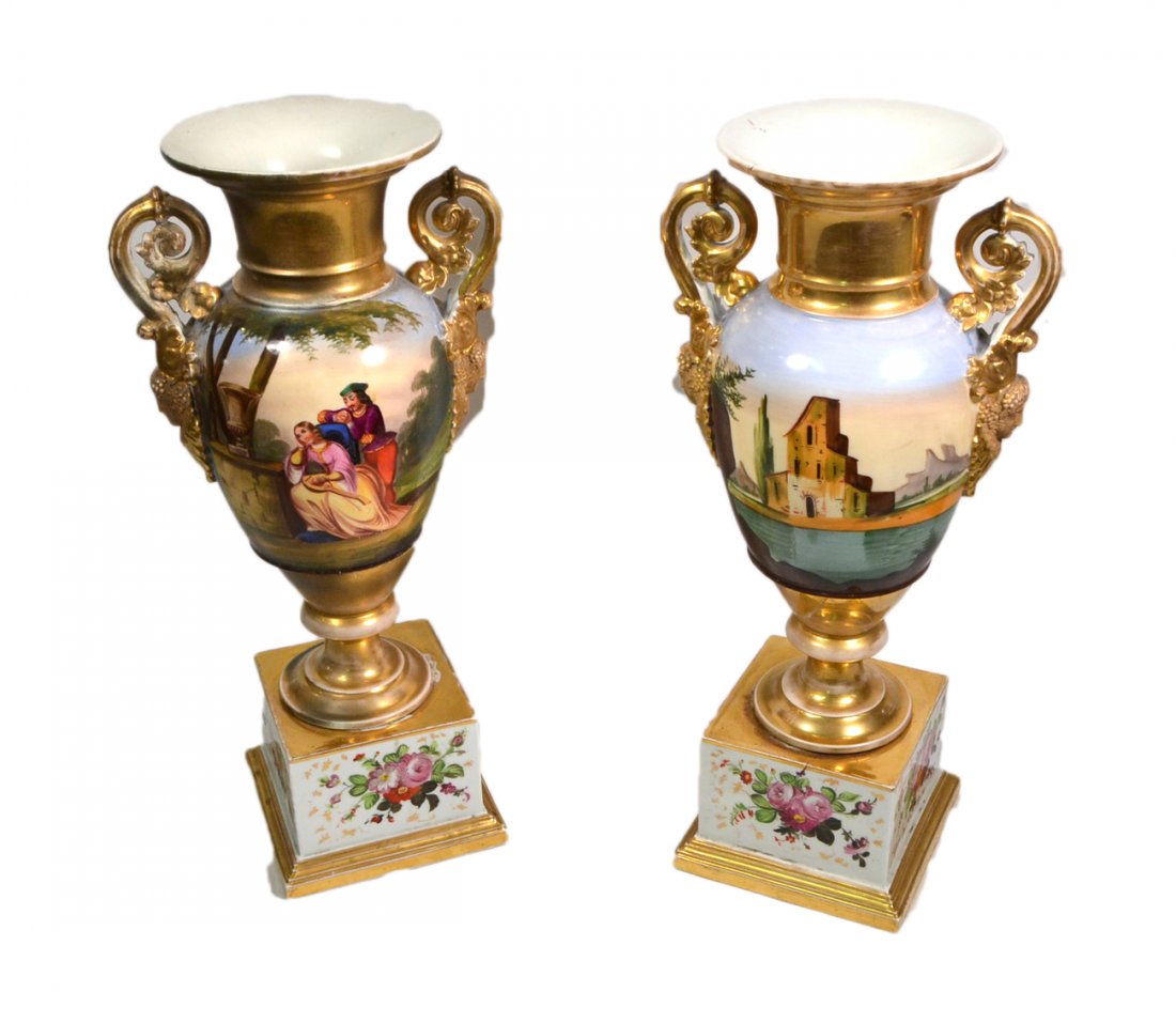 Pair of Paris Porcelain Vases: Empire-style vases on plinth bases with figures in a rustic landscape. [20" H]. Wear to gilding, one bears significant restoration.