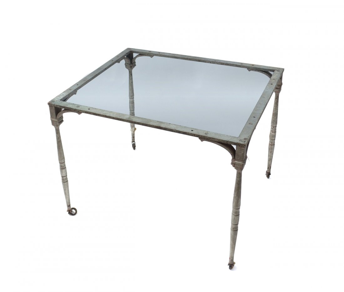 Iron Trolley Cart: Iron trolley cart with square glass top mounted on four casters. [44 1/2" W x 26 1/2" D x 29" H]. Worn condition, one wheel in need of repair.