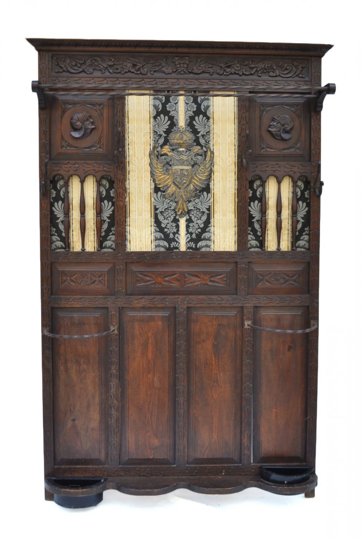 Ornate Coat Rack: Ornate and incised coat rack with two umbrella compartments. [49" W x 6" D x 76" H]. Good condition.