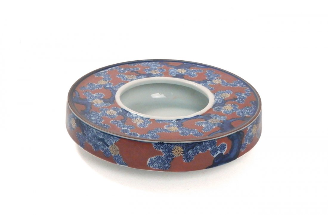 Asian Porcelain Bowl with Tree Motif: Porcelain bowl with ironstone red and blue trees motif with some gilding. Bears calligraphic inscriptions.[8 1/4" Dia x 2 1/4" H]. Good condition.