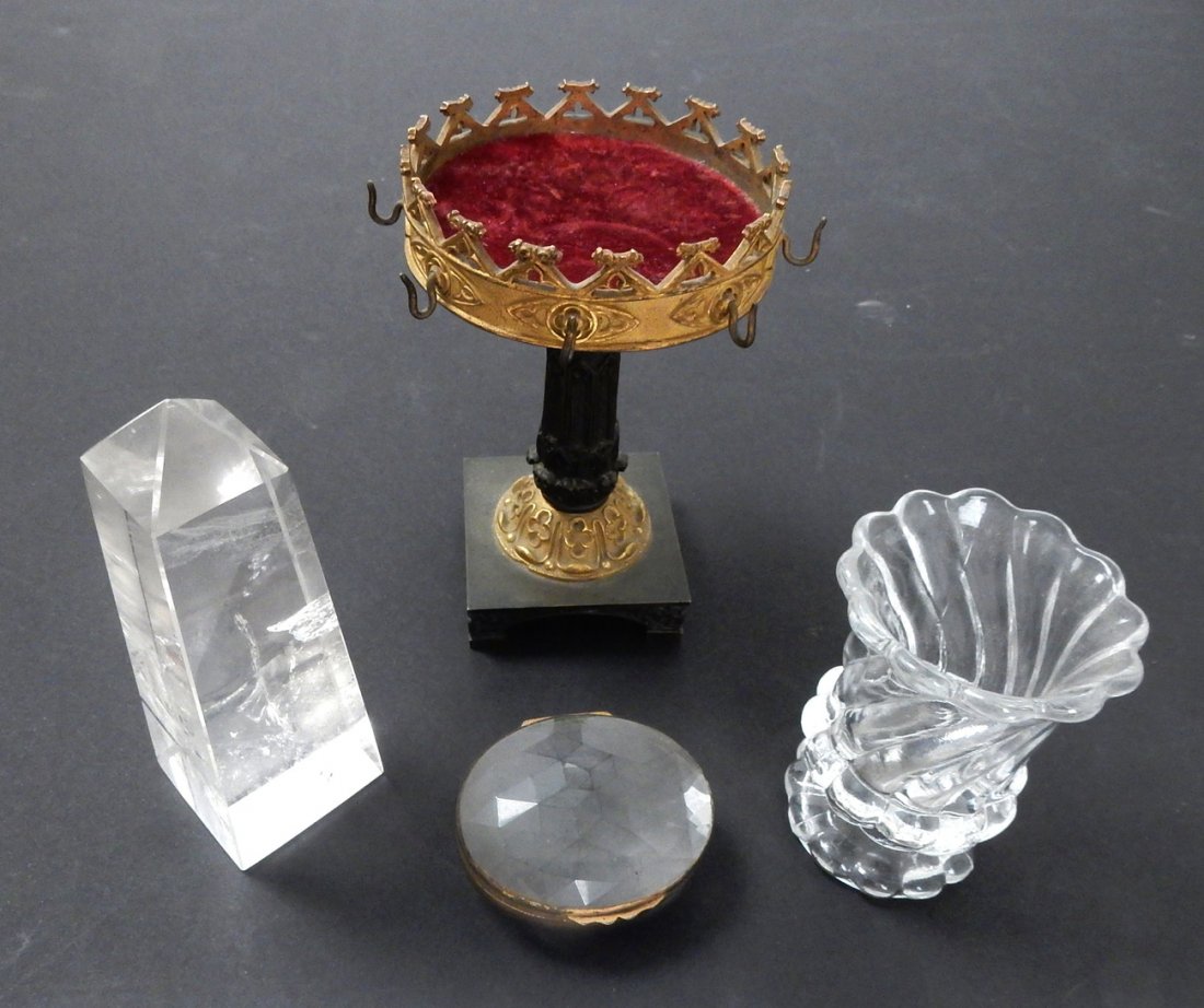 Four Crystal Items: Comprises: crystal obelisk, faceted crystal pill box, crystal toothpick holder, and a cast metal tazza with hooks. [Smallest: 2 1/8" x 1 3/4"; Tallest: 4" W x 4 3/4" H]. In good condition