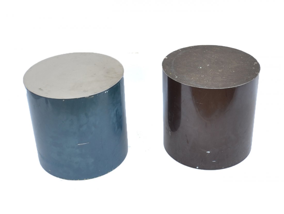 Two Industrial End Tables: Pair of industrial style metal cylinder shaped end tables, one blue and the other black. [18 1/4" Dia. x 18" H]. Top missing to on table, minor dents, paint loss, but structurally sound.