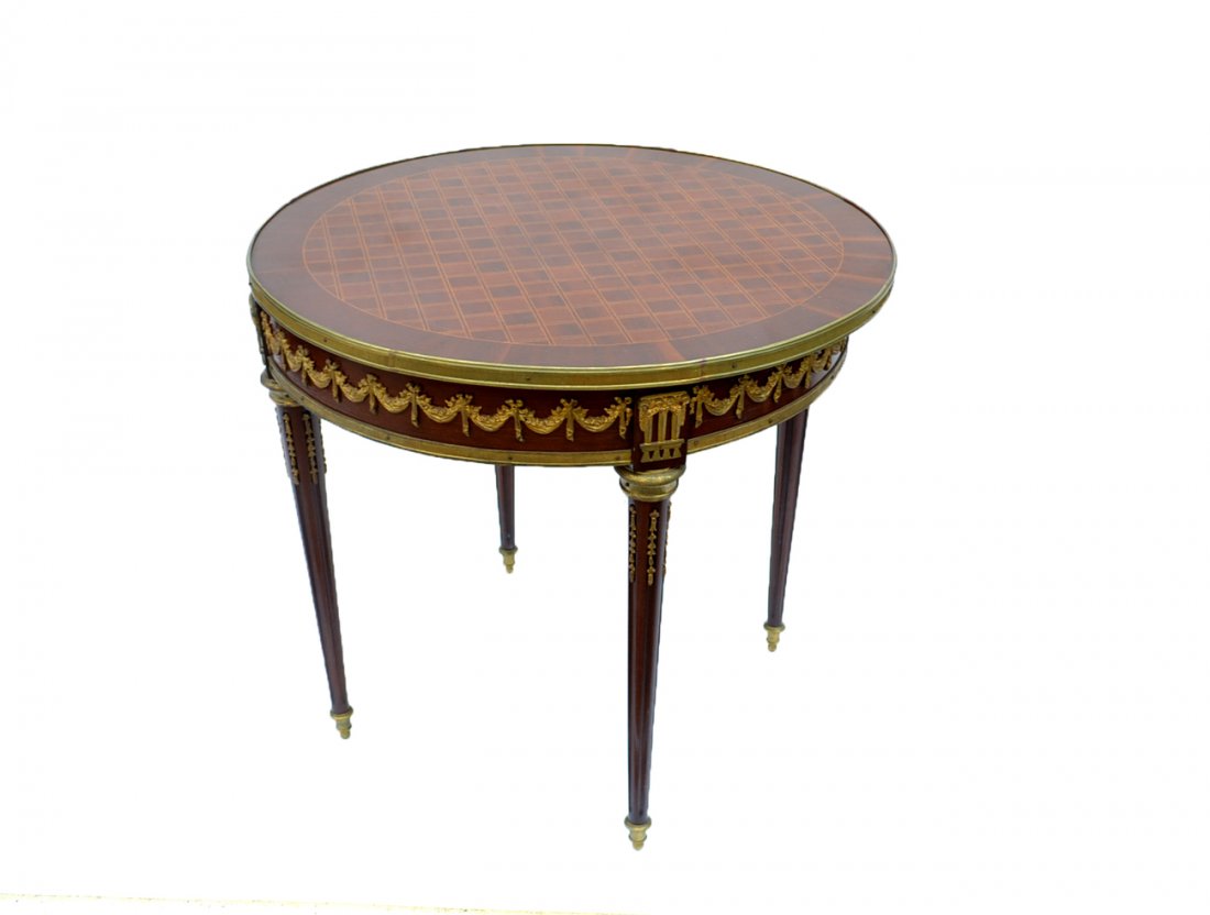 Neoclassical Style Round Table: Mahogany neoclassical style round table with bronze ornamentation. [32" Dia x 30" H]. Minor patina on bronze, and minor dents to bronze, otherwise in good condition.