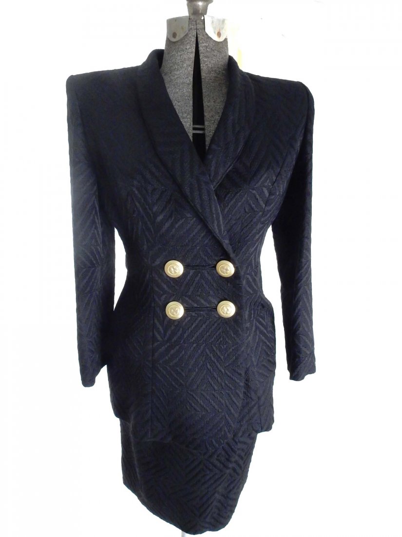 Black Bob Mackie Ladies Suit: Black Bob Mackie long double breasted jacket with matching skirt. Both bear Bob Mackie label. Style #820, size 8. New with original tags.