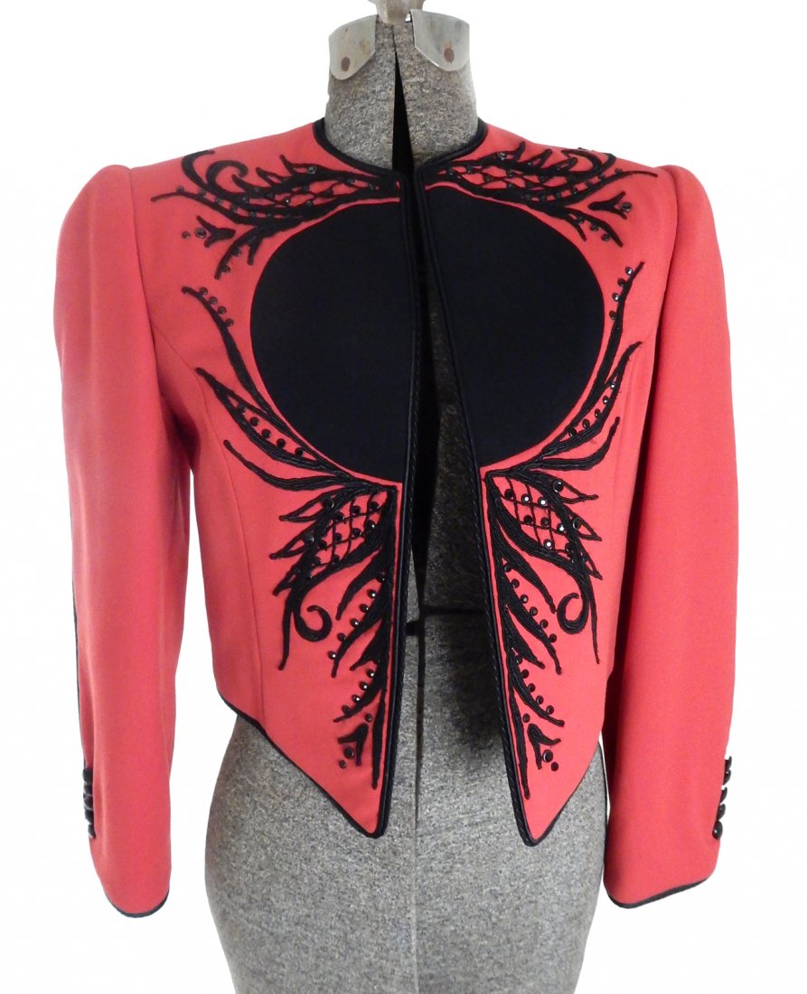 Red Bob Mackie Bolero Jacket: Bright red Bob Mackie bolero jacket with elaborate black embroidered and beaded decoration. Bears Bob Mackie label on inside. Size 8.