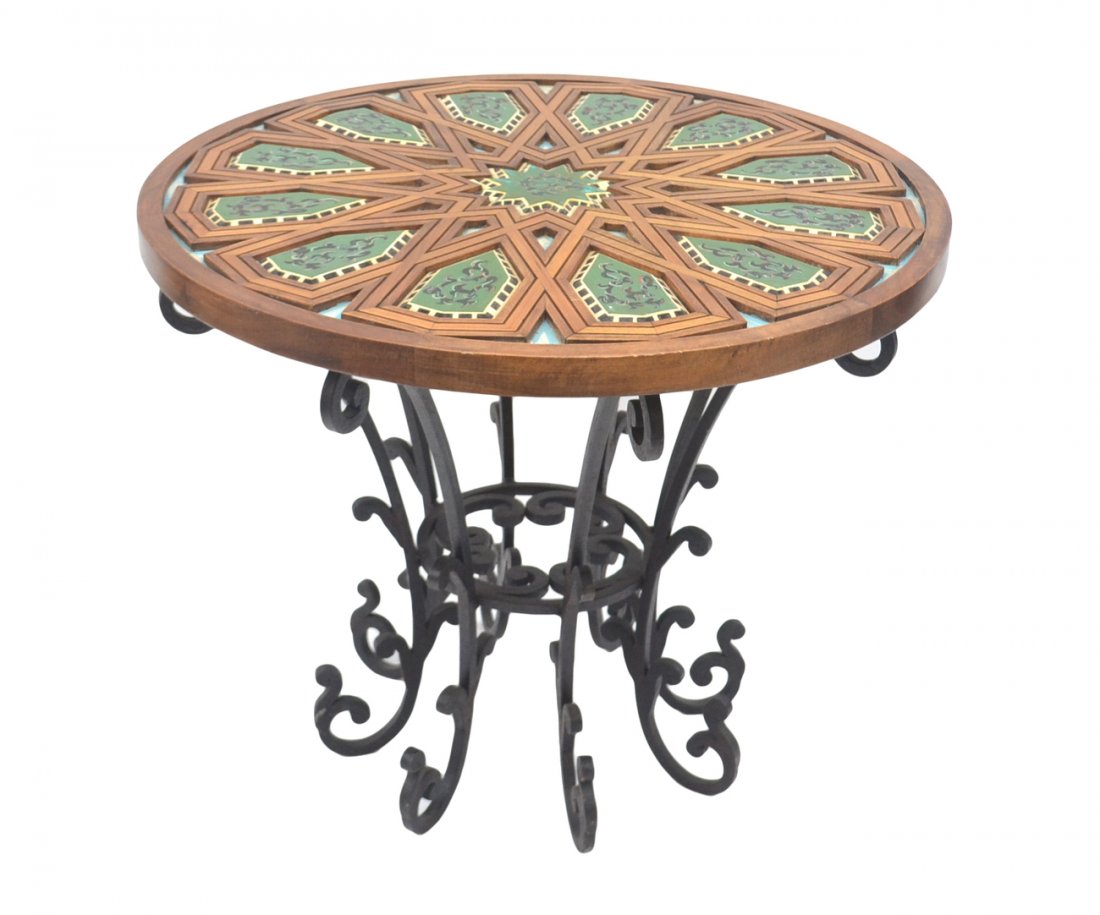Medieval-Style Round Table: Wood and iron round table having a geometric wood inlay top with painted inserts. [36" Dia. x 30" H]. In good condition.