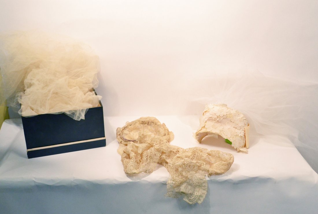 Group of Two Wedding Veils: Group of two vintage wedding veils. Comprising: 1.) Antique lace wedding cap with train, marked Henri Bendel. 2.) Wedding veil lace cap with attached veil on back. In overall good condition. Age tonin