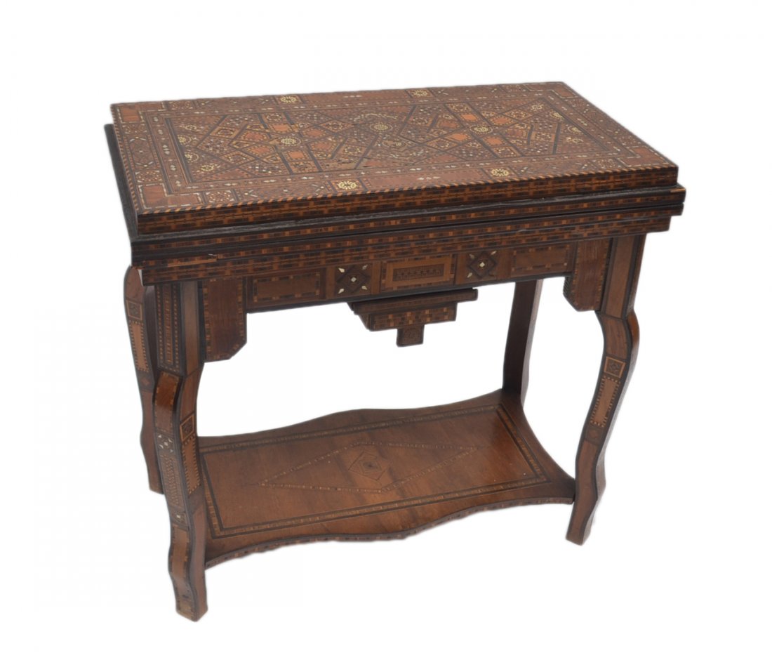 Antique Moroccan Inlaid Game Table: "Double Top" game table with all-over intricate geometric parquetry, featuring an inlay with mother-of-pearl accents. Bears two drawers and a lower shelf, and a hinged top conceals a green velvet play