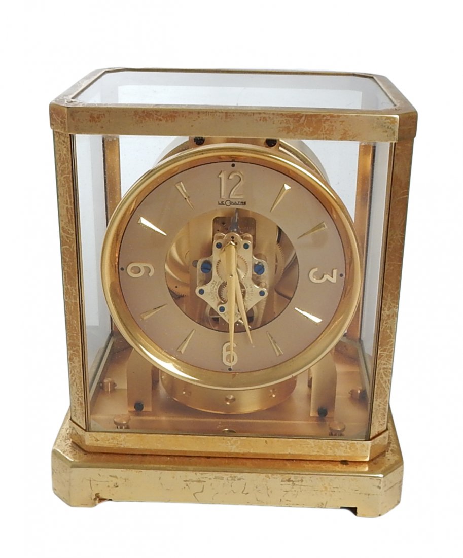 Le Coultre Atmos Mantle Clock: Le Coultre Atmos Clock, circa 1960s. Features a brass case with glass sides and top. Marked "Le Coultre" on dial. [8 1/4" W x 6 1/4" D x 9 1/4" H]. Works not tested. Surface scratches to base, otherwi