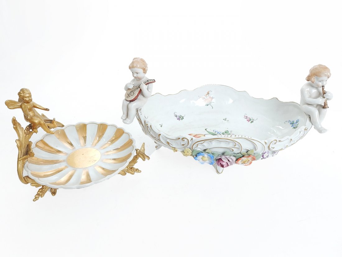 Porcelain Centerpiece & Gilded Plate: Comprising: 1.) Porcelain centerpiece with two cherubs playing instruments. Chips to applied flowers. "Schierholz", made in Germany. 2.) Gilded metal stand with cherub and birds. Porcelain plate with 
