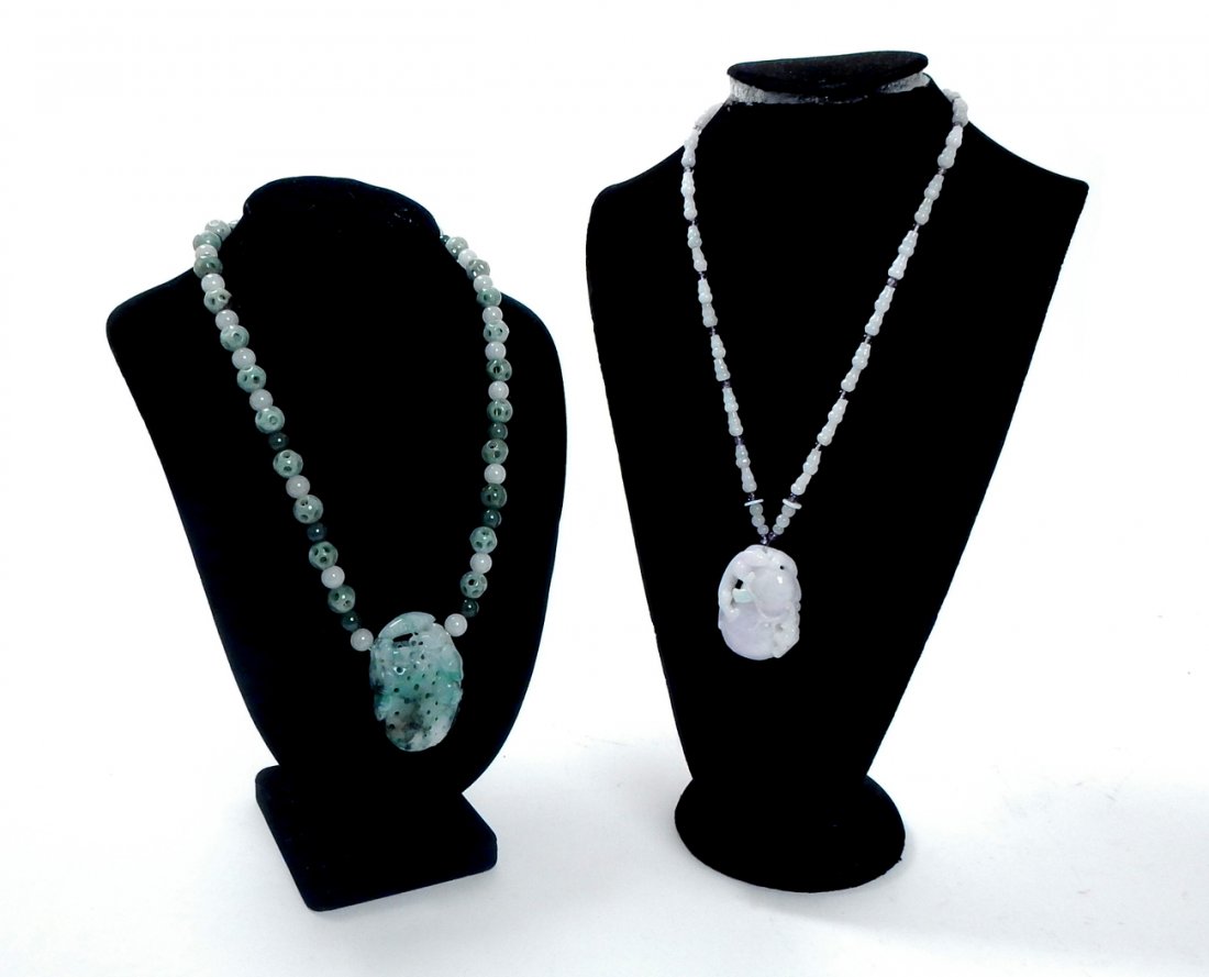 Two Jade Necklaces: Comprising: 1.) Spinach Jade beaded necklace with large reticulated fruit-form pendant [1 5/8" x 5/8" x 2 1/4"]. 2.) Mutton fat jade necklace with wild cat and bat carved pendant. [1 1/4" x 5/8" x 1 7