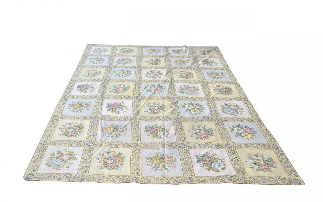 Flower Motif Needlepoint Rug: Needlepoint rug with 35 square medallions of flowers bordered by smaller flowers. [Rug dimensions: 167" x 113"]. In good condition.