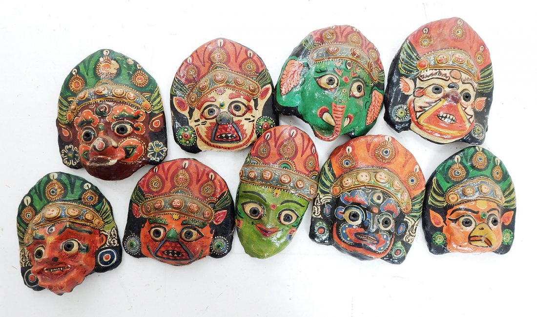 Nine Masks: Group of assorted painted tribal masks. [5 1/2" W x 6" H].