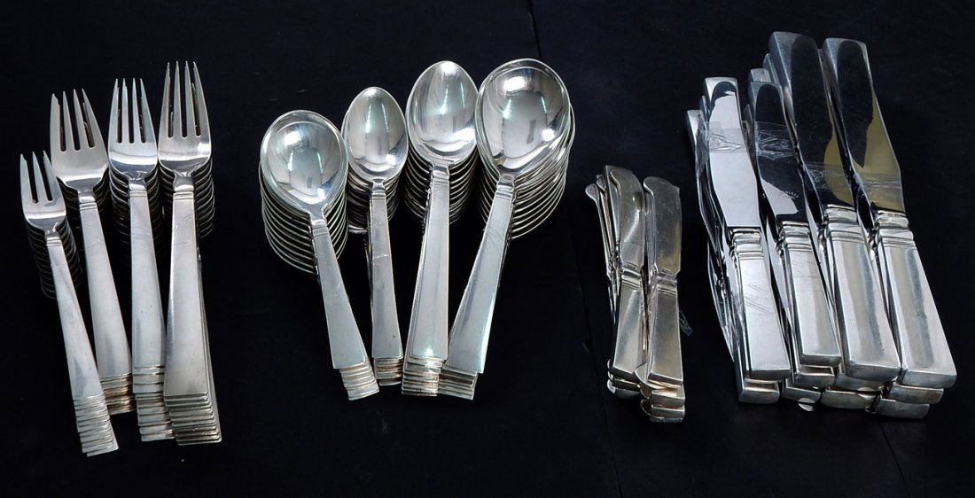 Georg Jensen Sterling Silver Flatware: Impressive service designed for Georg Jensen by IB Just Andersen in 1934. Comprises: 12 dinner forks, 13 salad forks, 11 dessert forks, 12 appetizer forks, 12 dinner knives, 12 salad knives, 13 butter