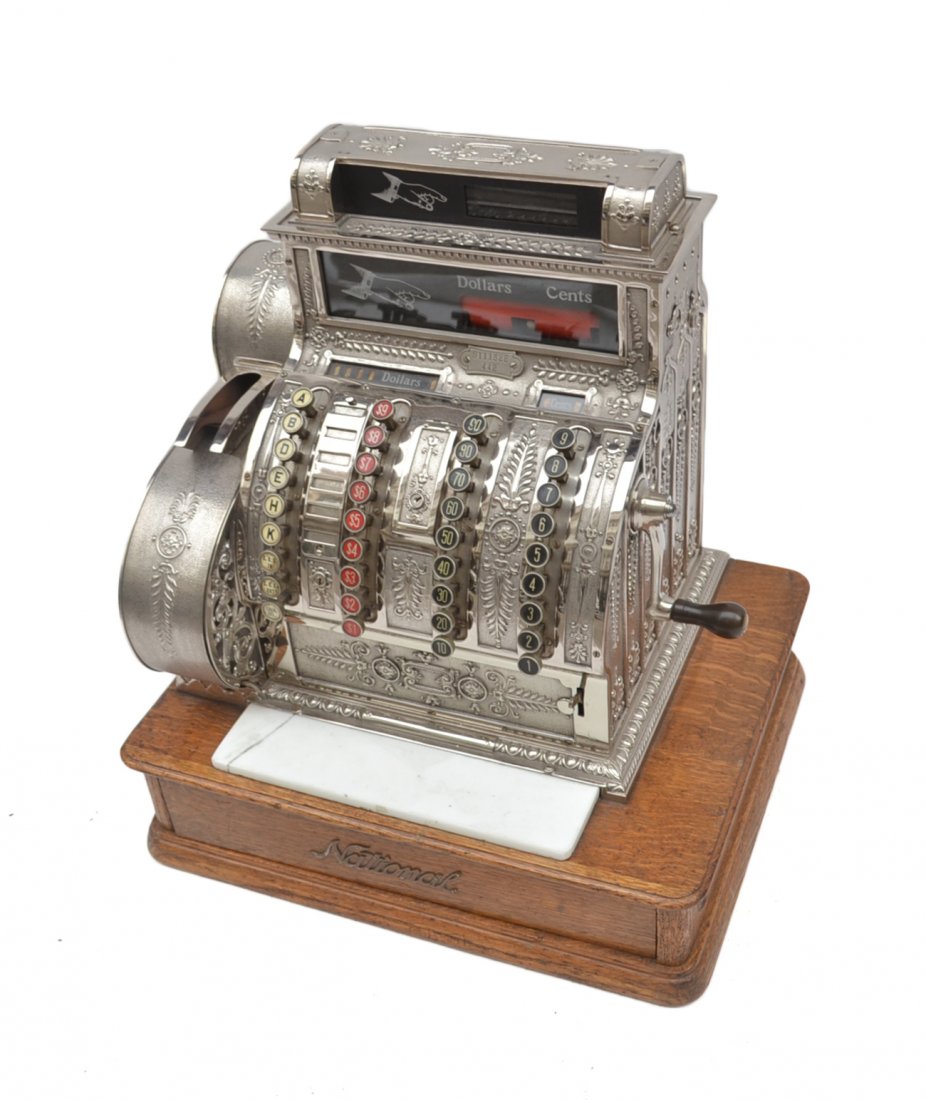 Vintage National Cash Register: Ornate nickel-plated bronze cash register on oak cash drawer. Serial #S111328/442. [20 1/2" W x 16 3/4" D x 22" H]. Cracked white glass details and light wear.