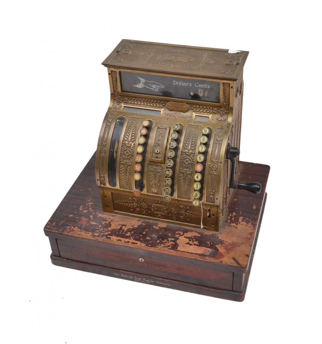 Vintage National Bronze Cash Register: Bears a cherry mahogany finish cash drawer base. Serial #S368531F/415. [20 3/4" W x 16" D x 19 1/2" H]. Wear throughout with unknown missing elements at top.