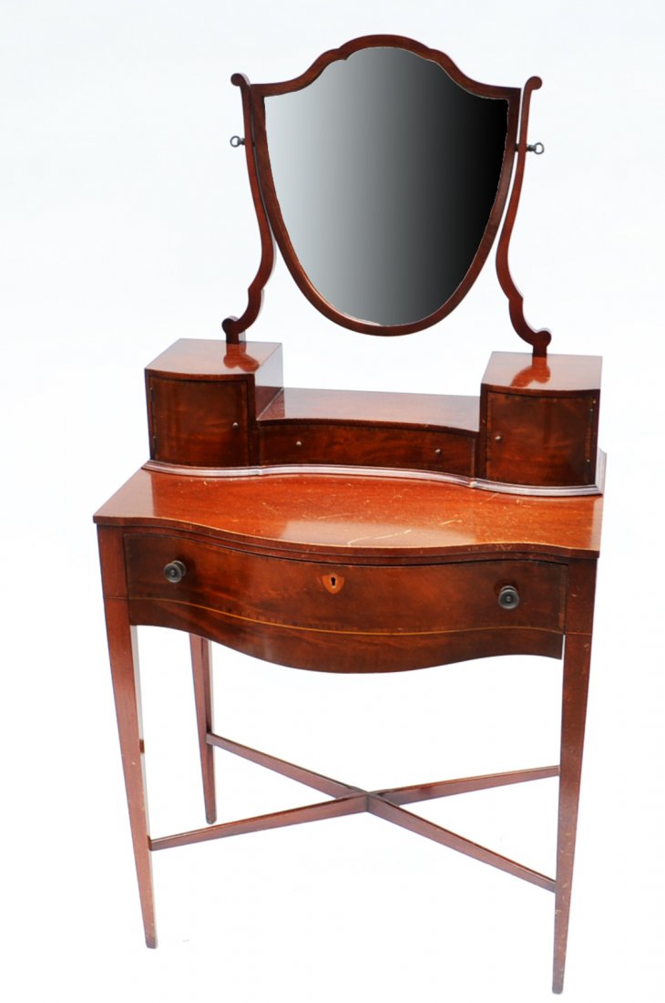 Mahogany Two-Piece Vanity: Mahogany two-piece serpentine-form vanity with inlaid doors and drawers. Features two drawers, two cabinets, and a swing mirror. [27" W x 15" D x 54"].
