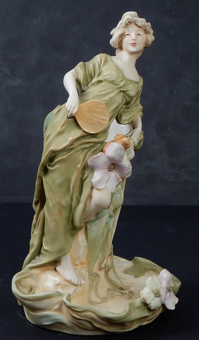 Royal Dux Woman: A ceramic female vase with floral decoration. [10 1/2" H]. Base drilled. Overall good condition.