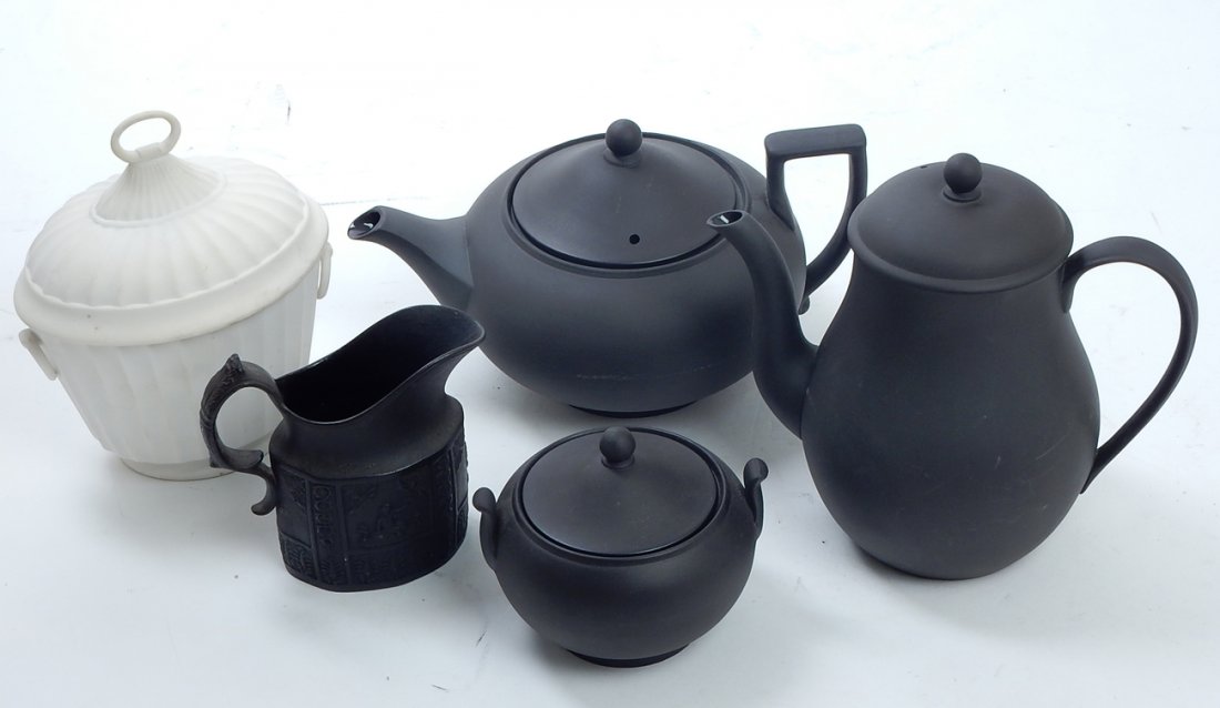 Lot of Wedgwood Black Basalt: Comprises: Wedgwood Black Basalt teapot, coffee pot and sugar bowl. Marked "Wedgwood, Made in England". Black Basalt creamer and white matte sugar bowl are unmarked. [Largest: 8 1/2" H x 8" W]. Good c