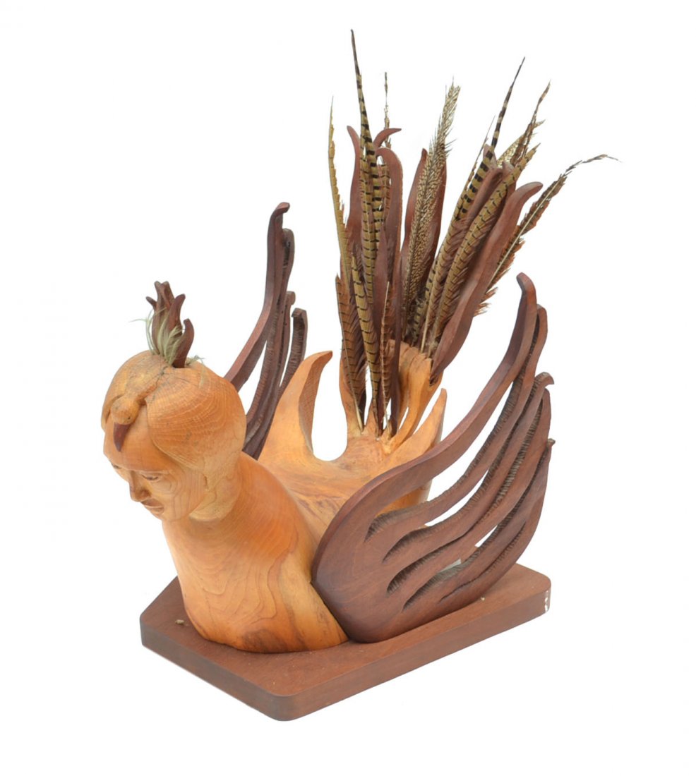 Attributed Leonora Arye Rooster: Highly stylized carved wood rooster with human male face, and feather accents. [20" W x 33" D x 34" H]. Some splitting with wood fill repair.