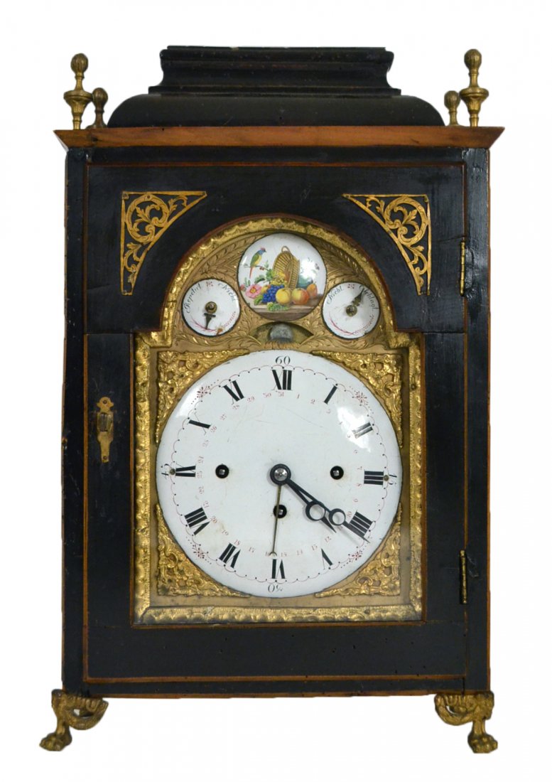 German Enameled Mantle Clock: German enameled dial mantel clock with tin face and tin plaque depicting fruit, a bird and a basket. [11 1/2" W x 19 1/2" H].