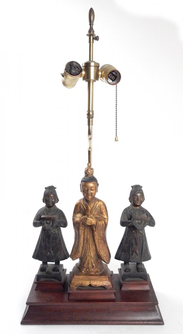 Bronze Figural Group Lamp: Three antique Chinese parcel gilt bronze figures mounted on a mahogany plinth base. Comprises a pair of attendants [each 8 3/4" H] flanking a Buddhist scholar [11 1/8" H]. [Overall: 12 1/2" W x 5 5/8"
