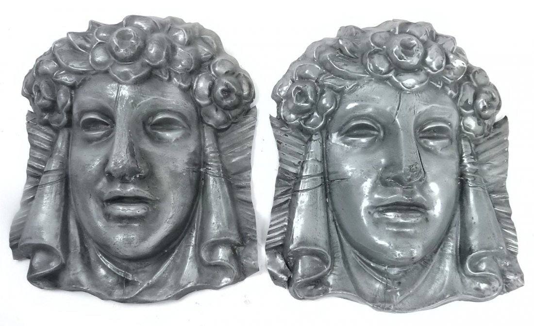 Metal Architectural Masks: Pair of repousse metal architectural masks. [15" H x 12 1/2" W x 4 1/2" D]. Some distressed splits.
