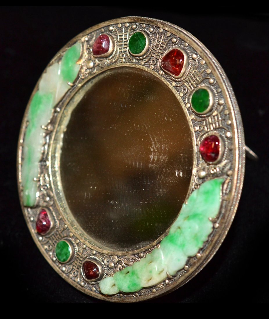 Chinese Fine Jade and Jeweled Mirror: Set in silver motif, the round loop encrusted with jade, rubies and emeralds. [4" Dia].