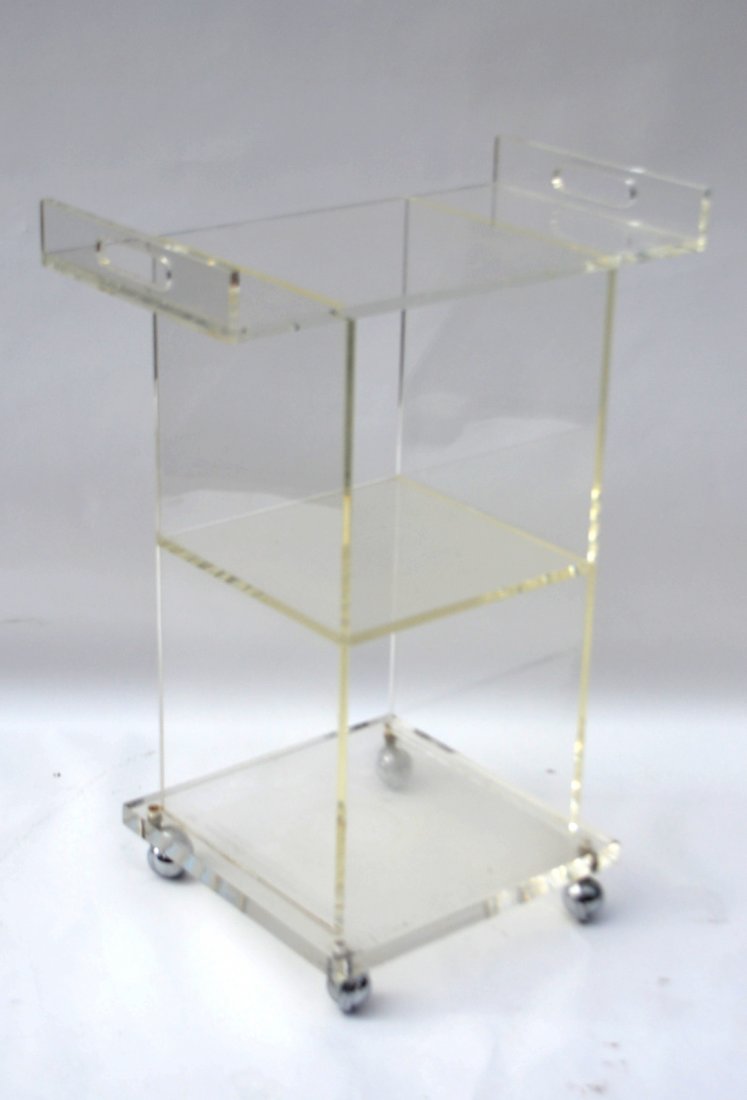 Lucite Cart: Modern Lucite three-tier serving cart on casters. [23" W x 12" D x 30" H]. Overall good condition.